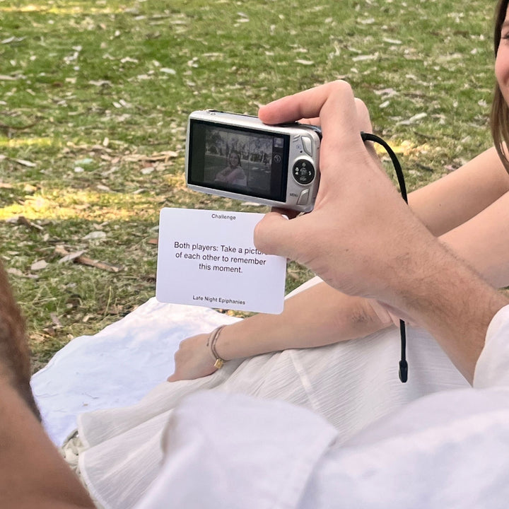 A challenge card of the Late Night Epiphanies Card Game from Level 3, where the players have to take a picture of each other and create a memory.