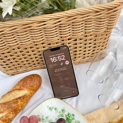 Image of an iPhone placed on a picnic with a Late Night Epiphanies wallpaper that says "some of your best days are still ahead."